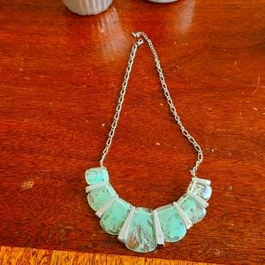 Necklace with light green silver pieces and silver chain.